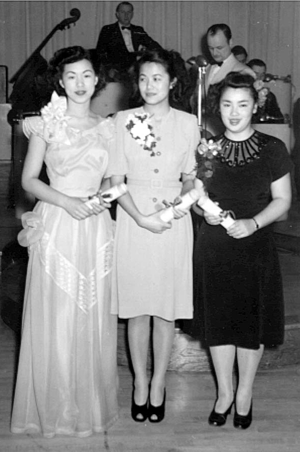 Black and white photo of three women in dresses