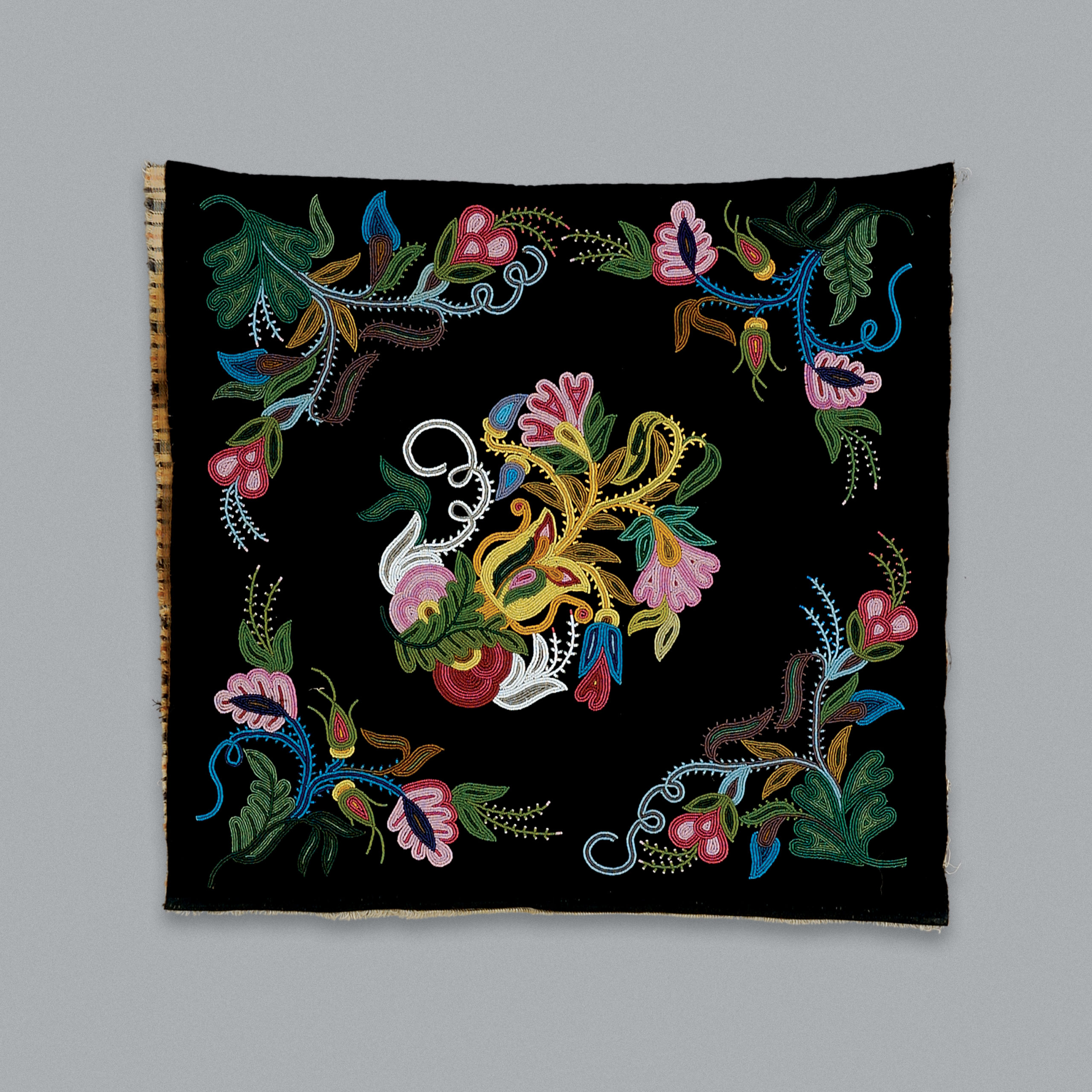 Flower designs beaded onto a black backing