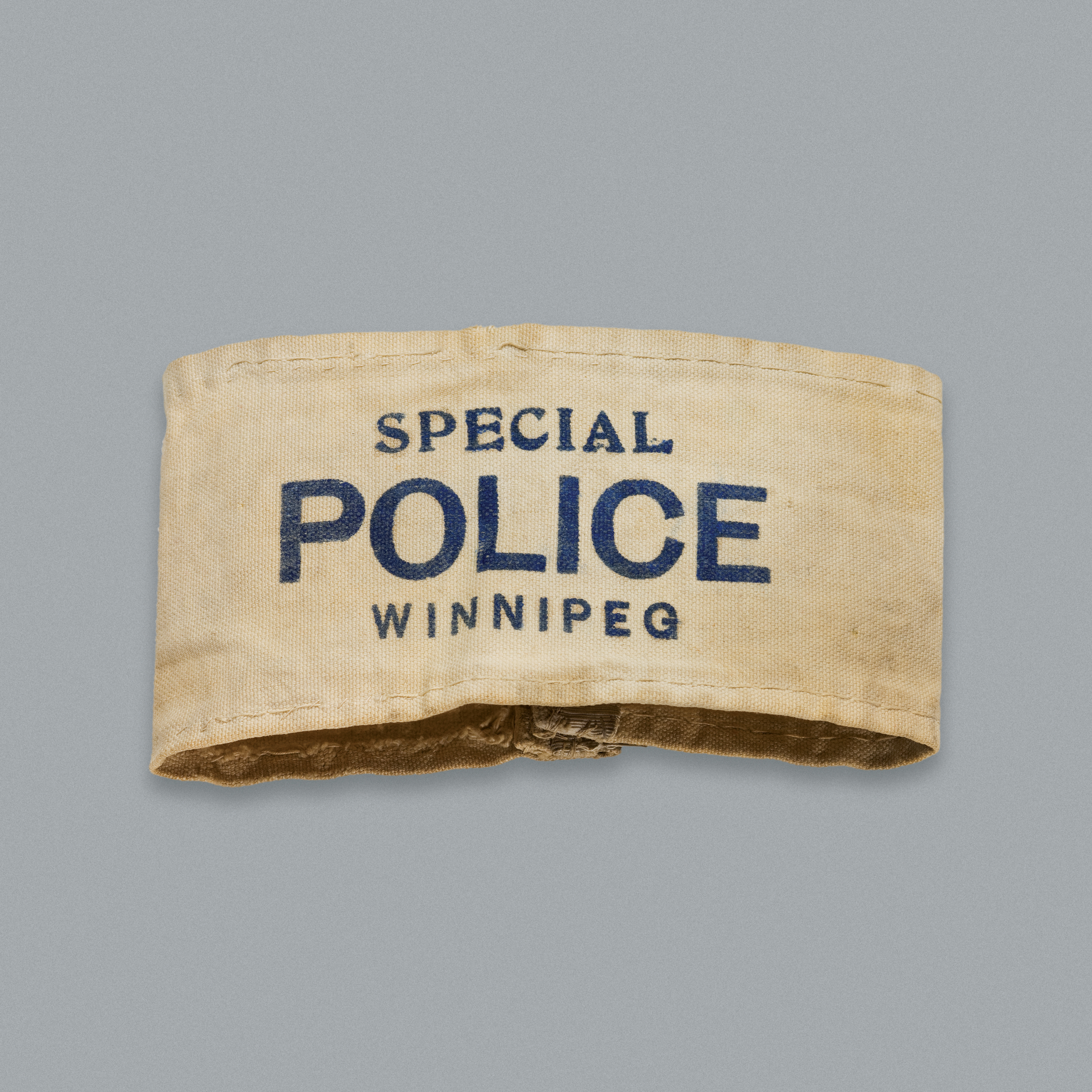 White cotton armband with “Special Police Winnipeg” on it