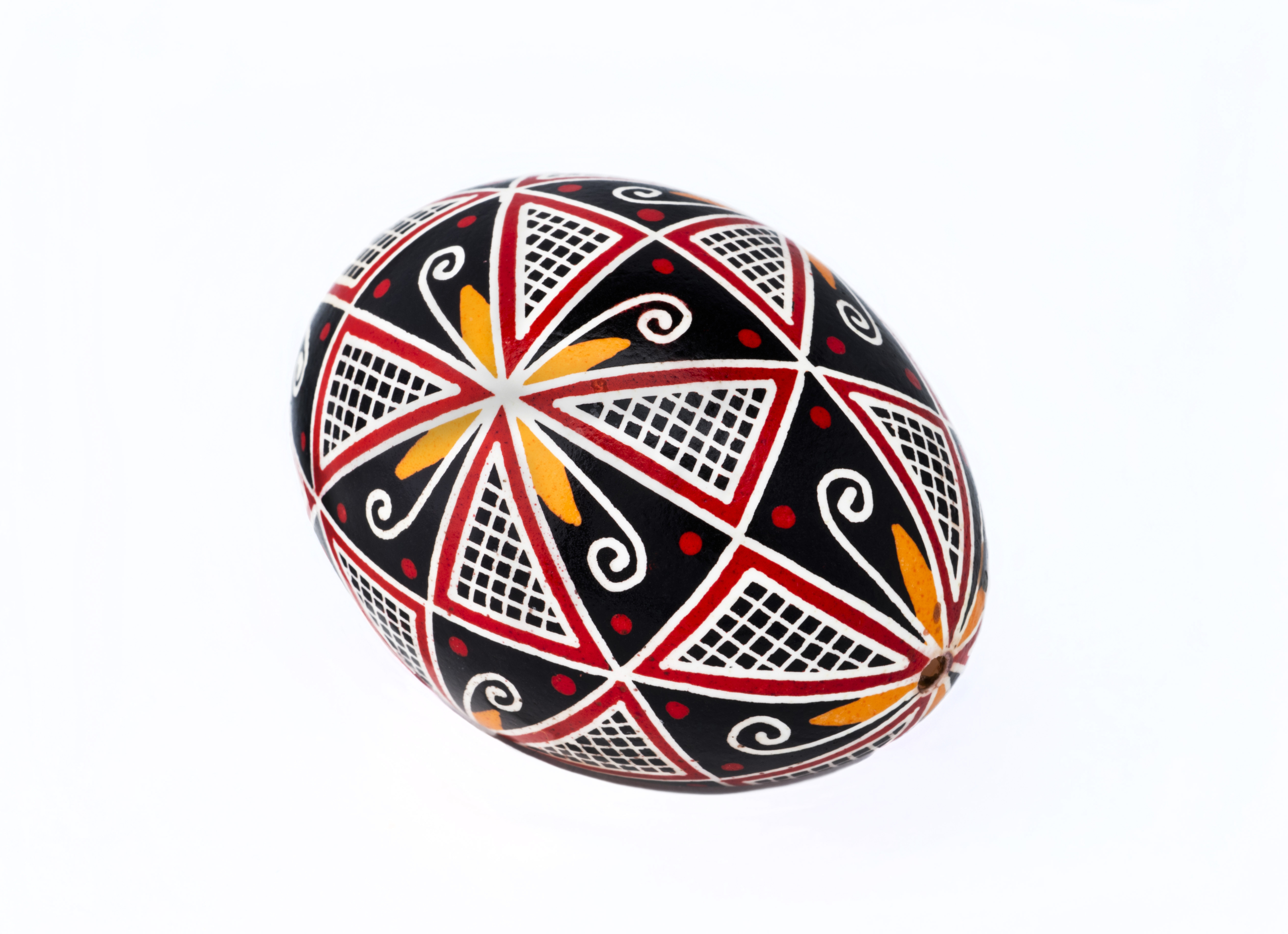 Egg with red, yellow and black geometric patterns
