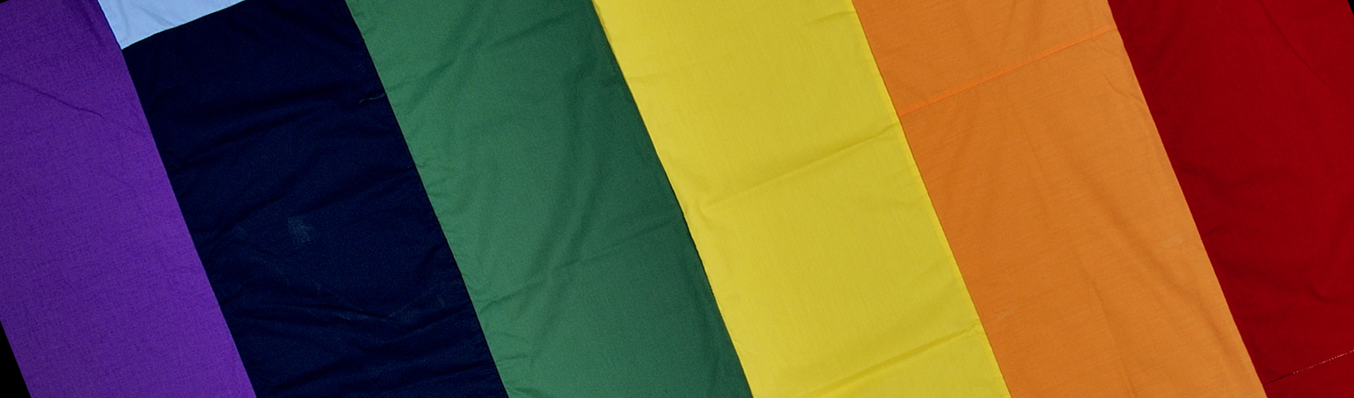 A square section of a rainbow banner on a grey background.