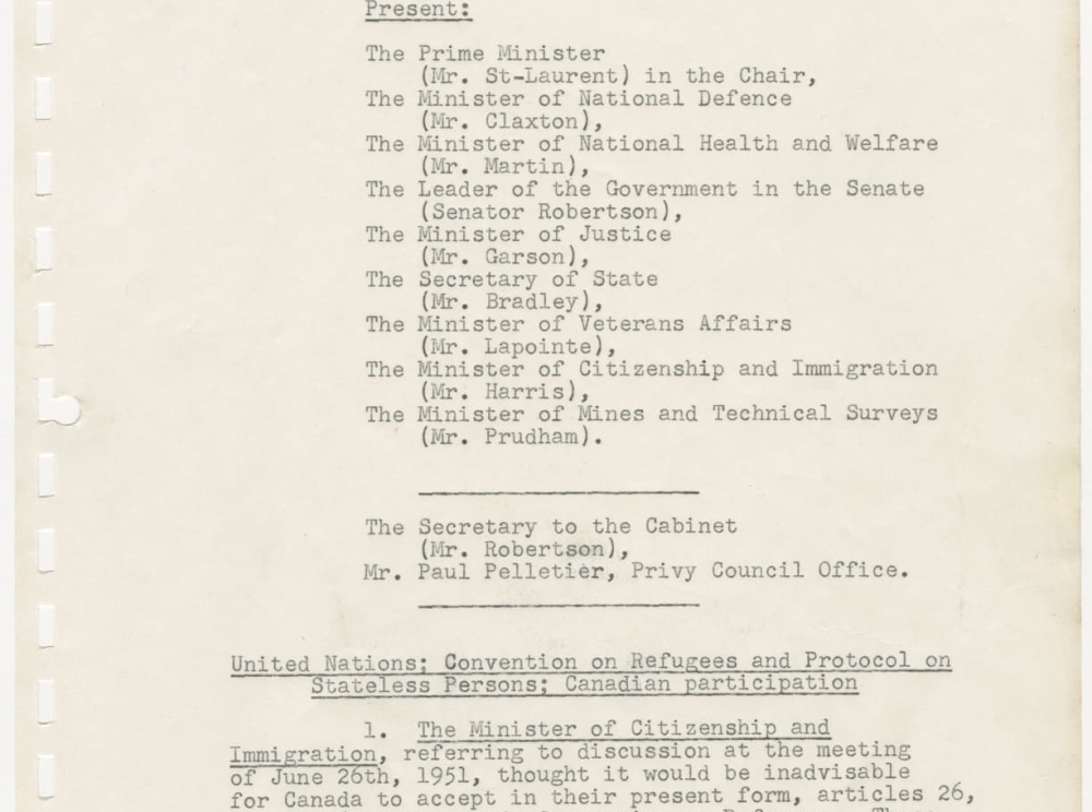 A long white page of paper with perforations on the lefthand side. Black type details the minutes of a Canadian Cabinet meeting.
